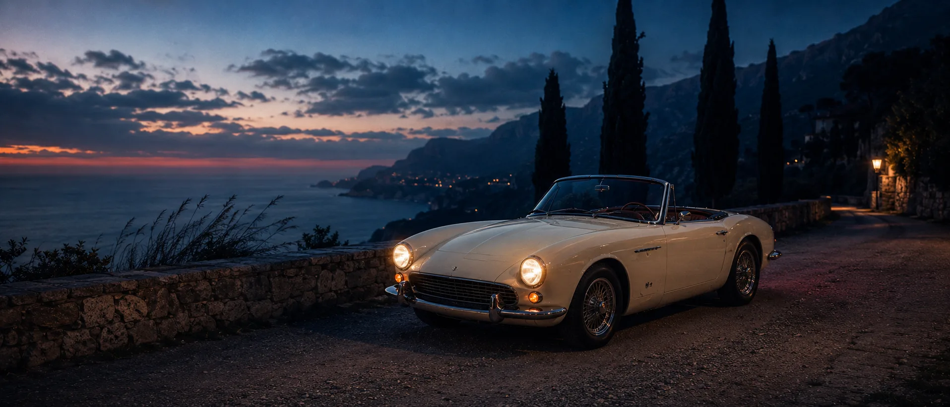 Refika — three-quarter view at blue hour, Mediterranean mountains receding into evening haze